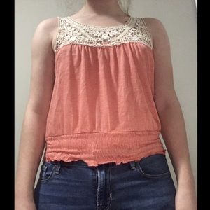 Small peach top fits almost like a belly shirt